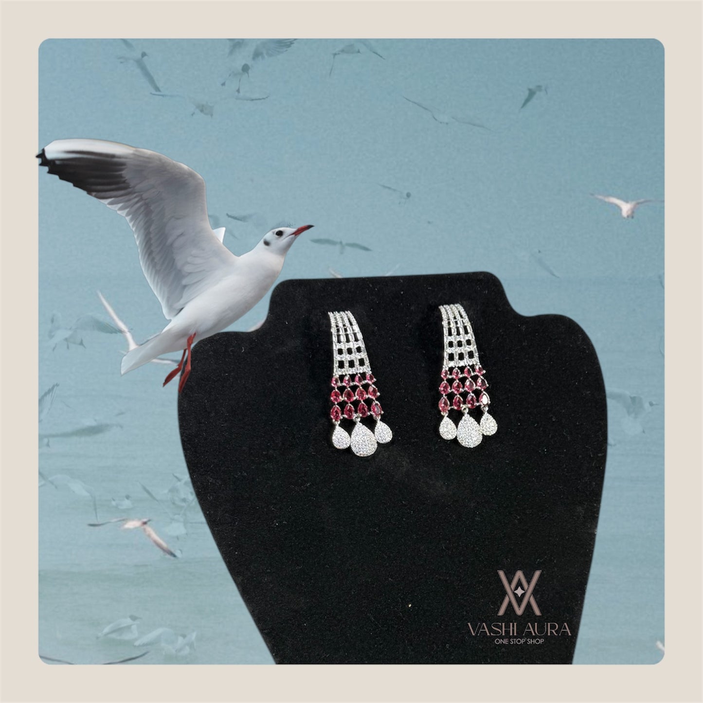 Long earrings featuring white CZs on the upper section complemented by red CZs in the middle and finished with elegant drops at the bottom
