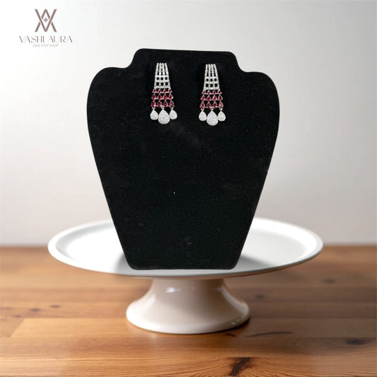 Long earrings featuring white CZs on the upper section complemented by red CZs in the middle and finished with elegant drops at the bottom